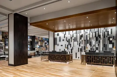 a lobby of a library with tables and chairs at Sheraton Gateway Hotel in Toronto International Airport in Mississauga