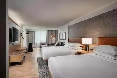 a hotel room with two beds and a television at Sheraton Gateway Hotel in Toronto International Airport in Mississauga