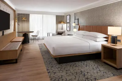 a hotel room with a large bed and a desk at Sheraton Gateway Hotel in Toronto International Airport in Mississauga