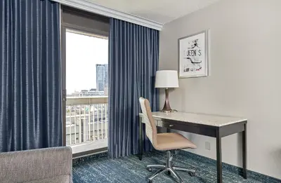 a hotel room with a desk and a window at Chelsea Hotel Toronto in Toronto