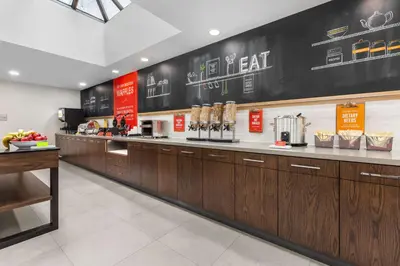 a fast food kitchen with wooden cabinets and a counter at Hampton Inn & Suites by Hilton Toronto Downtown in Toronto