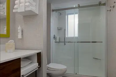 a bathroom with a toilet and a glass shower at Hampton Inn & Suites by Hilton Toronto Downtown in Toronto