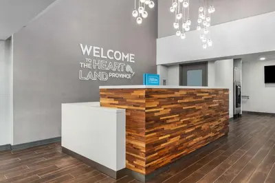 a lobby with a counter with a welcome to theart the herart land promise at Hampton Inn & Suites by Hilton Toronto Downtown in Toronto