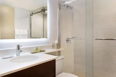 a bathroom with a sink and a shower at DoubleTree by Hilton Hotel Toronto Airport West in Mississauga