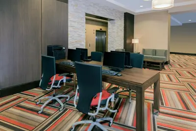 a conference room with a desk and chairs at Wyndham Grand Fallsview Hotel in Niagara Falls