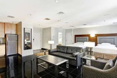 a hotel room with a bed and a couch at DoubleTree by Hilton Toronto Downtown in Toronto