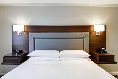 a bedroom with a large bed with two lamps on it at DoubleTree by Hilton Toronto Downtown in Toronto