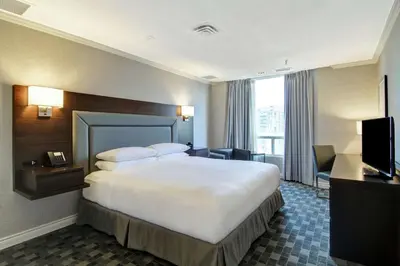 a hotel room with a large bed and a television at DoubleTree by Hilton Toronto Downtown in Toronto
