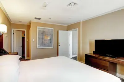 a bedroom with a large bed and a flat screen tv at DoubleTree by Hilton Toronto Downtown in Toronto