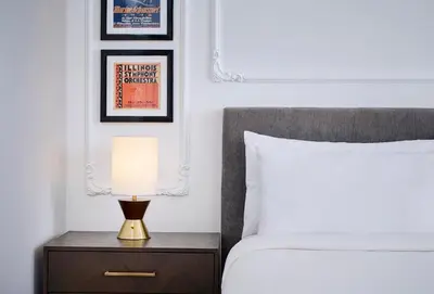 a lamp on a nightstand next to a bed at Pantages Hotel Toronto Centre in Toronto