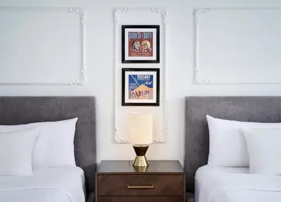 a bedroom with two beds and a table with a lamp at Pantages Hotel Toronto Centre in Toronto