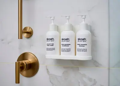 three bottles of bleach on a shelf in a bathroom at Pantages Hotel Toronto Centre in Toronto