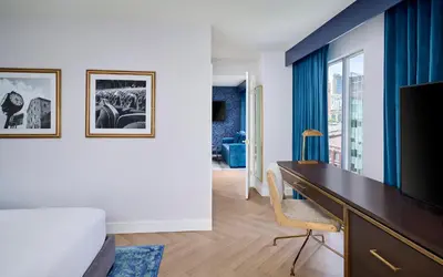a hotel room with a desk and a tv at Pantages Hotel Toronto Centre in Toronto