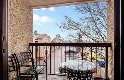 a balcony with a table and chairs and a view of a street at Best Western Plus Cairn Croft Hotel in Niagara Falls