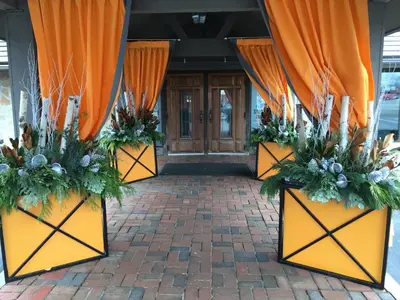 an entrance to a building with orange curtains and plants at Old Stone Inn Boutique Hotel in Niagara Falls
