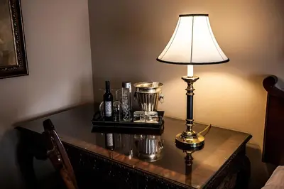 a table with a lamp on top of it at Old Stone Inn Boutique Hotel in Niagara Falls