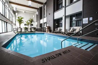 a swimming pool in the courtyard of a hotel at Old Stone Inn Boutique Hotel in Niagara Falls