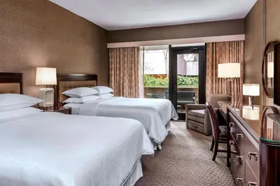 a hotel room with two beds and a window at Sheraton Centre Toronto Hotel in Toronto