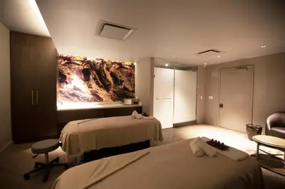 a hotel room with two beds and a painting on the wall at The Omni King Edward Hotel in Toronto