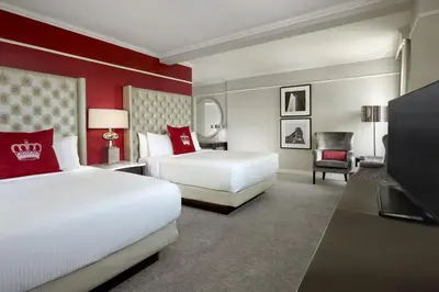 a hotel room with two beds and a television at The Omni King Edward Hotel in Toronto