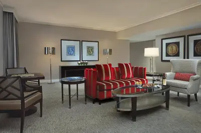 a living room with a couch and chairs and a table at The Omni King Edward Hotel in Toronto