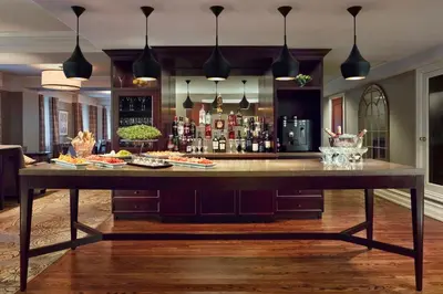 a large table in a room with a bar at The Omni King Edward Hotel in Toronto