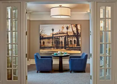 a dining room with a painting of a building at The Omni King Edward Hotel in Toronto