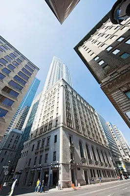 a tall white building in a city with tall buildings at One King West Hotel and Residence in Toronto