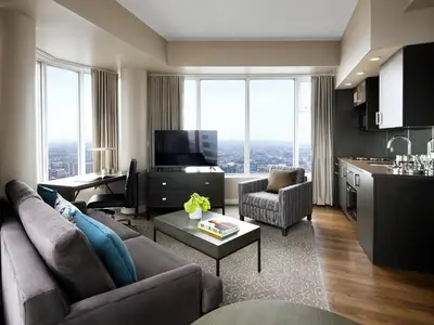 a living room with a couch and a table at One King West Hotel and Residence in Toronto
