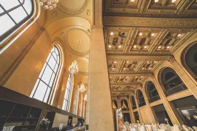 a large room with a ceiling and windows at One King West Hotel and Residence in Toronto