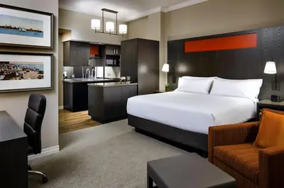 a hotel room with a bed and a kitchen at One King West Hotel and Residence in Toronto