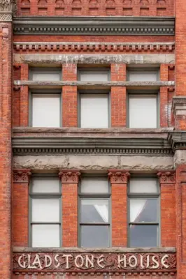 a tall red brick building with a sign on it at Gladstone House in Toronto