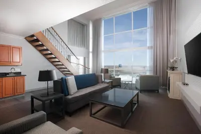 a living room with a couch and a table at Niagara Falls Marriott on the Falls in Niagara Falls