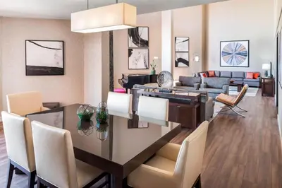 a dining room and living room with a table and chairs at The Westin Toronto Airport in Toronto