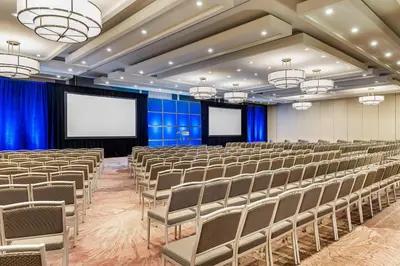 a conference room with chairs and a screen at The Westin Toronto Airport in Toronto