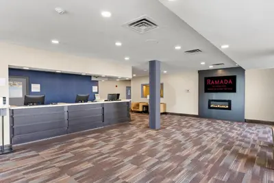 an empty lobby with a waiting room with a sign that reads ramana at Ramada By Wyndham Niagara Falls near the Falls in Niagara Falls