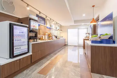 a restaurant with a large menu on the wall at Holiday Inn Express & Suites Mississauga-Toronto Southwest by IHG in Mississauga