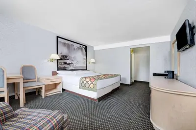 a hotel room with a bed and a tv at Super 8 by Wyndham Niagara Falls North in Niagara Falls