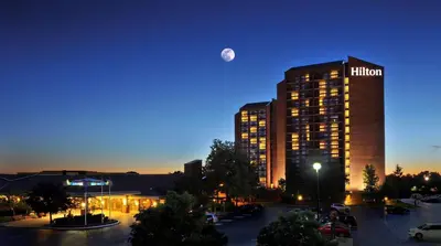 a hotel with the moon over a parking lot at Hilton Mississauga/Meadowvale in Mississauga