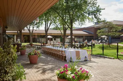 a table set up in a courtyard with flowers at Hilton Mississauga/Meadowvale in Mississauga