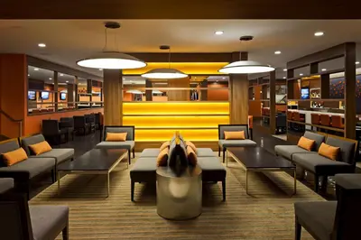 a waiting room with couches and tables in a library at Hilton Mississauga/Meadowvale in Mississauga
