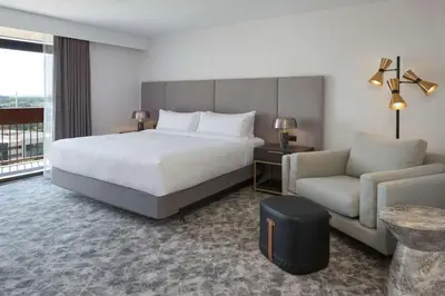 a hotel room with a bed and a couch at Hilton Mississauga/Meadowvale in Mississauga
