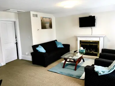 a living room with a couch and a fireplace at Ellis House Bed & Breakfast in Niagara Falls