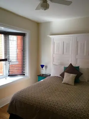 a bedroom with a large bed and a window at Ellis House Bed & Breakfast in Niagara Falls