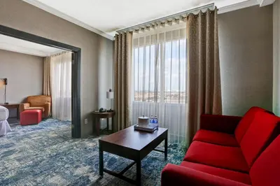 a living room with a red couch and a table at Four Points by Sheraton Toronto Mississauga in Mississauga