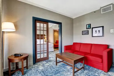 a living room with a red couch and a table at Four Points by Sheraton Toronto Mississauga in Mississauga