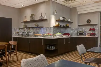 a kitchen with a counter with food on it at Four Points by Sheraton Toronto Mississauga in Mississauga
