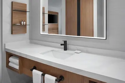 a bathroom with a white sink and a mirror at Delta Hotels by Marriott Toronto Markham in Markham