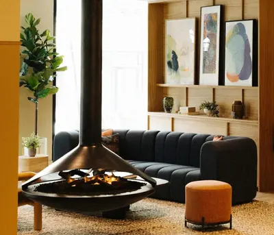 a living room with a couch and a fire pit at Union Hotel in Toronto