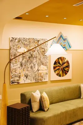 a living room with a green couch and a painting at Union Hotel in Toronto